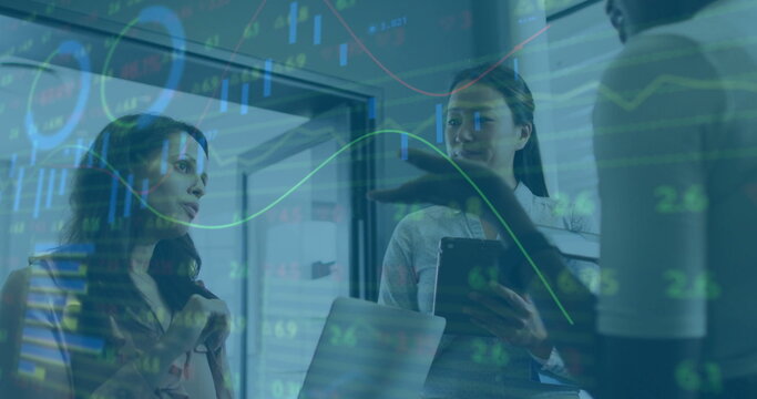 Image of financial data processing over diverse female colleagues discussing work in office