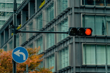 Japanese Traffic light installed at intersection in downtown Tokyo, Japan to prevent accident and...