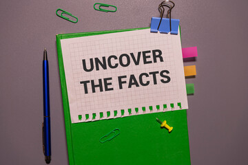 Uncover the facts quotes text on paper.