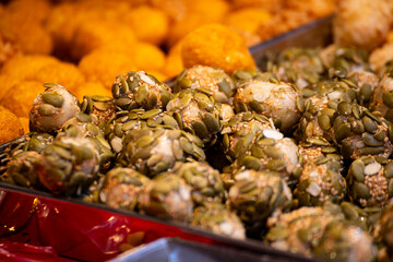 a plate of golden rice candy is piled high
