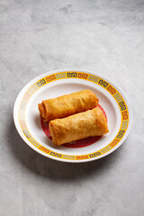 egg roll on marble background on chinese plate