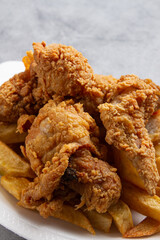 fried chicken with french fries with marble background