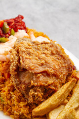 broaster chicken and homemade fries with rice and sweet and sour chicken with a marble grey background
