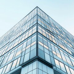 Fototapeta premium modern minimalist building with grid windows, clean lines, light facade, clear blue sky background, and urban architectural design.