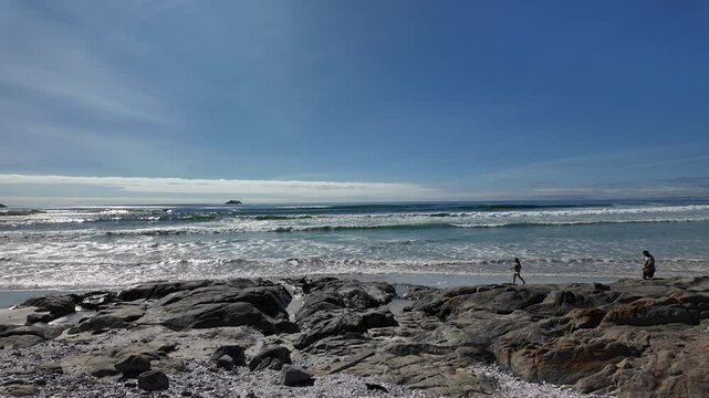 Yzerfontein West Coast South Africa. 07.01.2025. Video.  Yzerfontein a seaside town on the west coast with a sandy beach which runs north for sixteen miles towards Langebaan. Couple walking on beach.
