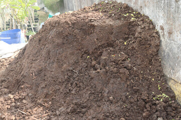 Heap of compost fertilizer on field