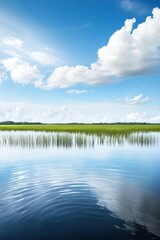 Obraz premium Serene Landscape of River and Sky with Soft Clouds