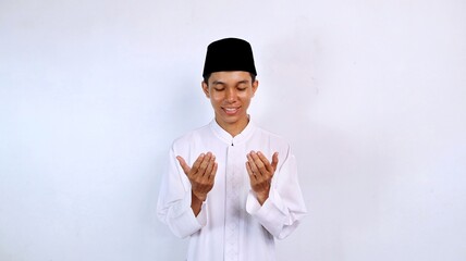 handsome asian muslim youth smiling gesture hands raised praying with isolated white background