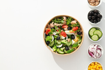 Tuna salad in a cardboard plate on a light table.