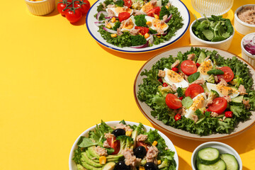 Salad with tuna on a yellow background.