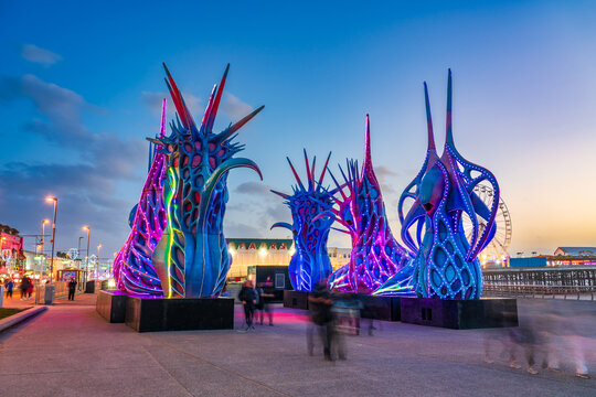 Blackpool beach and promenade with tourist attractions at dusk