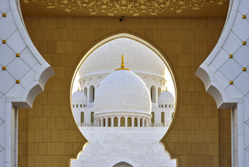 Abu Dhabi, United Arab Emirates - April 28, 2024: Front view of arch entrance door against dome roof of Sheikh Zayed Grand Mosque © JinChang