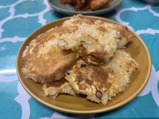 Pile of baked and grilled sticky rice serving on the plate. Famous traditional rice menu in Asia.