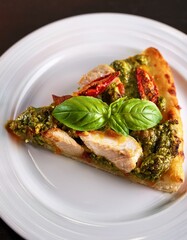 A slice of pesto chicken pizza, fresh basil, sun-dried tomatoes.
