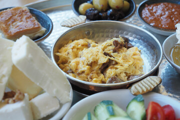 Traditional Breakfast Platter with Eggs, Cheese, Vegetables, and Bread Selection