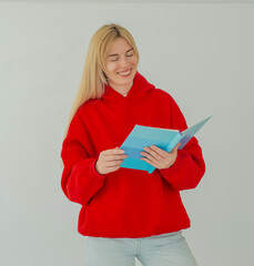girl in red sweater with book