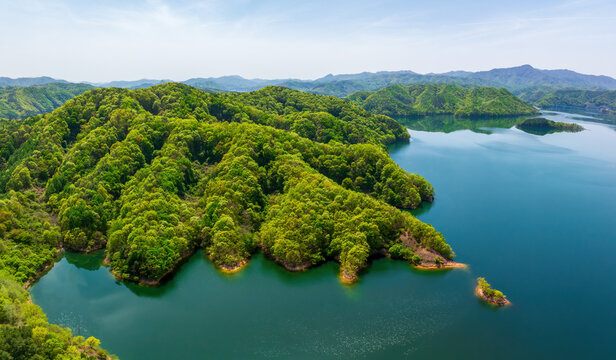 Aerial and spring view of Yongdamho Lake with green trees on mountain with ridges near Jinan-gun, South Korea