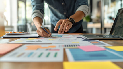 Obraz premium close up of a man is working on a office deskttop chart