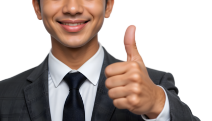 Close-up of smiling businessman giving thumbs up.