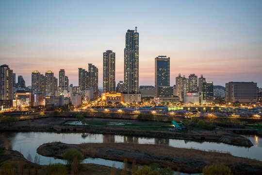 Mok-dong, Yangcheon-gu, Seoul, South Korea - April 7, 2024: High angle and sunset view of Anyangcheon Stream against road and building of Hyundai Hyperion