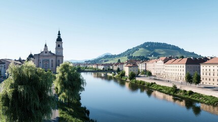 Obraz premium Scenic riverside view with buildings and hills under clear sky.