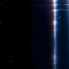Abstract Light Streak Illuminates Dark Background with Dust Particles