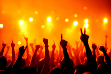 Fototapeta premium Silhouetted Crowd Raises Hands Enthusiastically at a Vibrant Concert with Bright Orange Lighting
