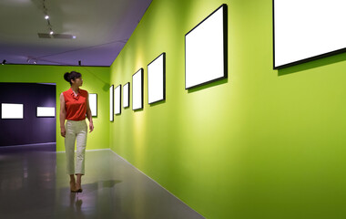 Woman walking and looking blank pictures