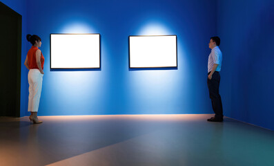 Businessman and businesswoman looking blank pictures