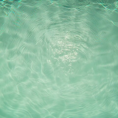 Tranquil Turquoise Water Surface with Ripples and Sunlight Glimmering Gently in Pool