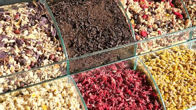 Colorful Assortment of Spices and Dried Herbs in Transparent Containers