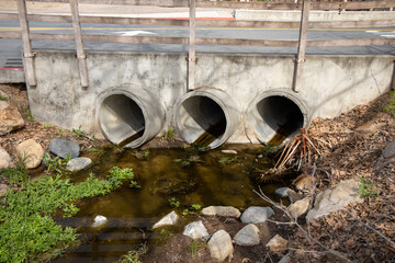 View of three culverts draining into a water ditch.