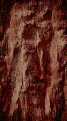 Naklejka premium Rough Textured Red Rock Surface Shows Natural Formation with Cracks and Crevices in Detail