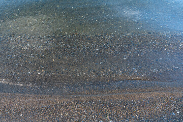 Obraz premium Wet stones on the lake shore beautiful color rocks close up view