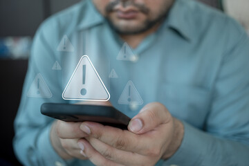 Unhappy man see warning triangles showing system errors warning caution for mobile phone...