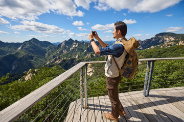 Happy man hiking in the mountains