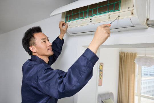 Handyman fixing the air conditioner