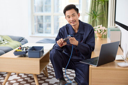 IT technician fixing internet cable