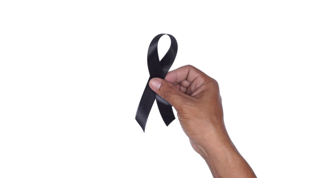 Hand holding black ribbon isolated on transparent background. Melanoma awareness and mourning concept