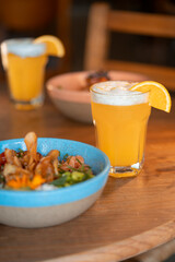 A refreshing glass of cold beer paired with a healthy meal. The scene combines indulgence and wellness, offering a perfect balance between a flavorful beer and a nutritious, fresh dish.