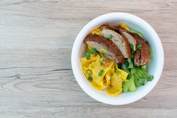 Dumplings with kale, Bok Choy (Chinese mustard greens) and roast duck on wooden table, Top view.