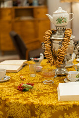 Retro style room with table, tablecloth, books, pastries
