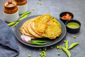 Matar paratha is a delicious Indian flatbread stuffed with spiced mashed green peas, cooked until golden and served with chutney.