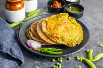 Matar paratha is a delicious Indian flatbread stuffed with spiced mashed green peas, cooked until golden and served with chutney.