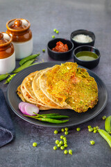 Matar paratha is a delicious Indian flatbread stuffed with spiced mashed green peas, cooked until golden and served with chutney.