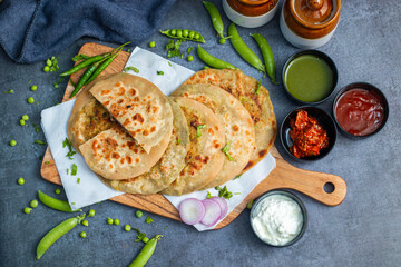Matar paratha is a delicious Indian flatbread stuffed with spiced mashed green peas, cooked until golden and served with chutney.