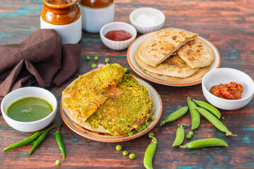 Matar paratha is a delicious Indian flatbread stuffed with spiced mashed green peas, cooked until golden and served with chutney.