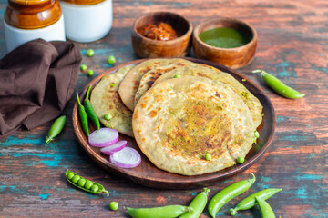 Matar paratha is a delicious Indian flatbread stuffed with spiced mashed green peas, cooked until golden and served with chutney.