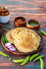 Matar paratha is a delicious Indian flatbread stuffed with spiced mashed green peas, cooked until golden and served with chutney.