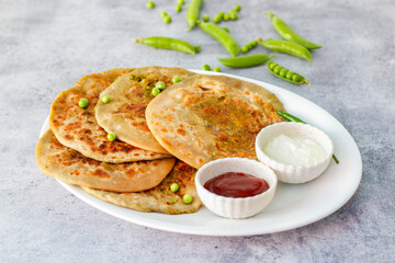 Matar paratha is a delicious Indian flatbread stuffed with spiced mashed green peas, cooked until golden and served with chutney.